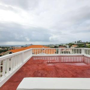 a balcony with a white railing and red dirt at 1 Bed Apt overlooking Rodney Bay in Gros Islet