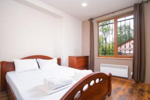 a bedroom with a white bed and a window at Dilijan Dream House! 3 Bedroom Amazing Villa in National Park! in Dilijan