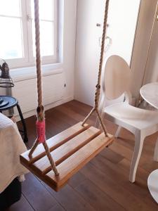 a wooden swing in a room at -La Maison Balancoire - Parking privé offert - Coeur historique -La Clef de Honfleur in Honfleur