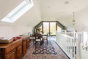 a dining room with a wooden table and chairs at Delightful Country Cottage in a lovely rural area in Ludlow