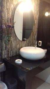 a bathroom with a sink and a mirror on a counter at Villa Anita Piriapolis in Piriápolis