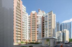 a group of tall buildings in a city at 1088 Cozy apartment in residential complex ''French Quarter1 in Kyiv