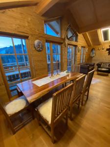 a dining room with a wooden table and chairs at Jagdhütte in Lachtal