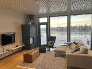 a living room with a couch and a tv at Arctic Riverside Villa in Rovaniemi