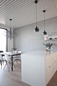a kitchen and dining room with a table and chairs at Arctic Riverside Villa in Rovaniemi