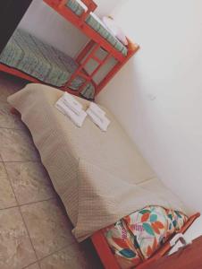 a bed in a room with a shelf on the wall at Alquileres Oeste 1 in Puerto Madryn