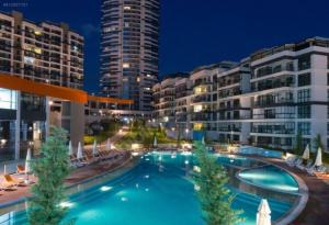 a large swimming pool in front of some buildings at Lux Residance 40th floor, sound system, 65 inch TV in Ankara