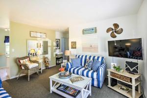 uma sala de estar com um sofá e uma televisão em Cozy NSB Abode with BBQ and Fire Pit - Walk to Beach! em New Smyrna Beach