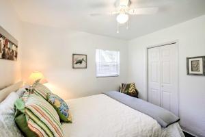 a bedroom with a bed and a ceiling fan at Cozy NSB Abode with BBQ and Fire Pit - Walk to Beach! in New Smyrna Beach