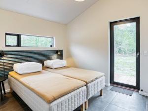 a bedroom with a bed with two pillows on it at 8 person holiday home in Læsø-By Traum in Læsø