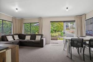 a living room with a couch and a table at Gorgeous 2BR Central Akl Retreat - WI-FI - Netflix in Auckland