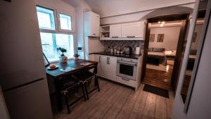 a kitchen with a desk and a table in it at La Garcon in Braşov