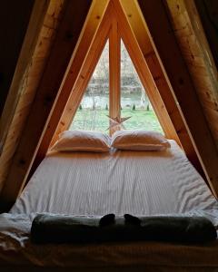 a bed in a room with a window at Brvnara Riva in Niš