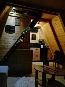 an attic room with a staircase and a table at Brvnara Riva in Niš