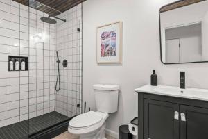 a bathroom with a shower and a toilet and a sink at Campfire Bungalow - Kid Friendly in Palenville +27 photos
