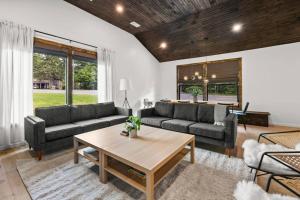 a living room with two couches and a table at Campfire Bungalow - Kid Friendly in Palenville