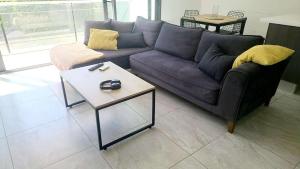 a living room with a couch and a coffee table at Track Apartment in Scala
