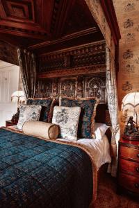 a bedroom with a large bed with a canopy at Belleek Castle, Ballina in Ballina