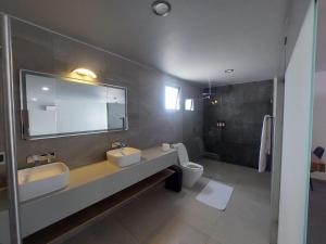 a bathroom with two sinks and a toilet at Oaxaca Inn Reforma in Oaxaca City