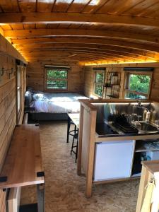 a kitchen with a sink and a bed in a room at Cool de Sources in La Hulpe