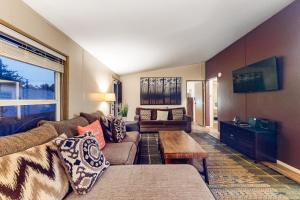 a living room with a couch and a table at BLK Beach House in Florence