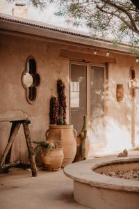 a patio with plants and vases in front of a building at Kay El Bar Guest Ranch in Wickenburg