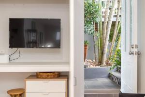 a living room with a tv on a wall at Contemporary Studio in the heart of Paddington in Brisbane