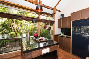 a kitchen with an aquarium in the middle of a room at Villa Bhuvana with private swimming pool in Gili Trawangan