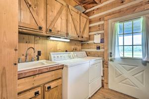 a white washer and dryer in a kitchen with wooden walls at Sweetens Ranch in South Pittsburg