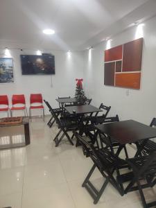 a group of tables and chairs in a room at Hostel Princess Copacabana in Rio de Janeiro