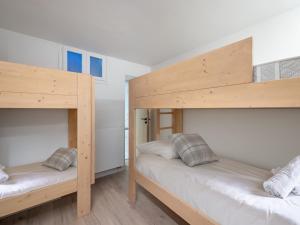 two bunk beds in a room with white walls at Appartement Courchevel 1850, 3 pièces, 6 personnes - FR-1-564-80 in Courchevel