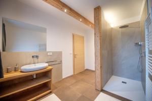 a bathroom with a sink and a shower at Apartments Stua da Carlo in Ortisei +15 photos