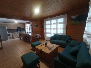 a living room with blue couches and a table at Chalet les Alpes - Le Sapey in Vénosc