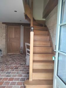 a staircase in a house with wooden floors and a door at Les Chambres de Moulière 