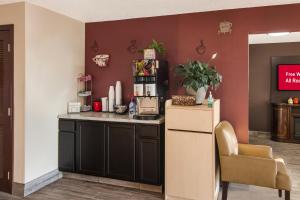 a kitchen with a counter and a chair at Red Roof Inn Greensburg in Greensburg