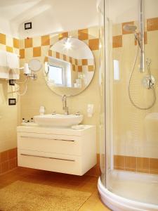 a bathroom with a sink and a shower at Albergo Milano Snc in Lanzo dʼIntelvi +39 photos
