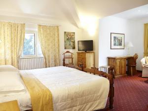 a hotel room with a bed and a television at Albergo Milano Snc in Lanzo dʼIntelvi