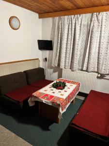 a living room with a couch and a table at Chata Tatranka in Štôla