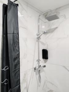 y baño con ducha con cortina negra. en Stara Pošta Apartment 8, en Grosuplje