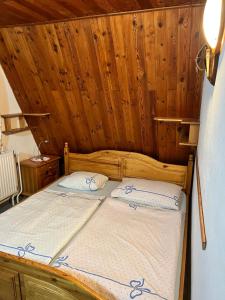 a bedroom with a bed in a wooden room at Chata Tatranka in Štôla