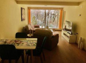 a living room with a couch and a table at Imanje POGLED in Arandelovac