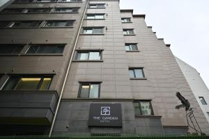 a tall building with a sign in front of it at The garden hotel in Seoul