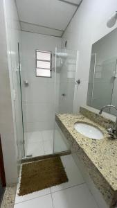 y baño con ducha acristalada y lavamanos. en Suítes Nosso Lar, en Río de Janeiro