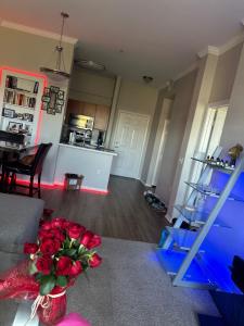 a living room with a vase of red roses on the floor at 1Bedroom Chic apartment in Phoenix