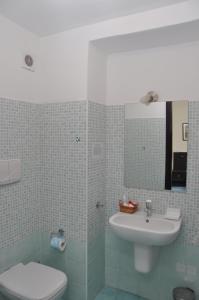 a bathroom with a toilet and a sink at B&B Stella Maris in Diamante