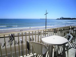 a table and chairs on a balcony overlooking the beach at Appartement Les Sables-d'Olonne, 4 pièces, 5 personnes - FR-1-197-199 in Les Sables-d'Olonne