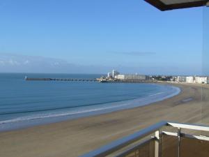 a view of a beach with buildings and the ocean at Appartement Les Sables-d'Olonne, 3 pièces, 4 personnes - FR-1-197-207 in Les Sables-d'Olonne