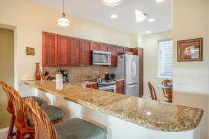 a kitchen with a counter top and a refrigerator at Waikoloa Fairway Villas #L22 in Waikoloa