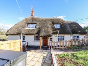 a thatch roofed house with a thatched at Posbury Lodge in Crediton