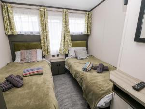 two beds in a small room with a window at Ramsey in Haverfordwest